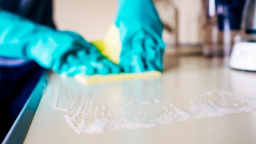 Cleaner using protective equipment during a cleaning task